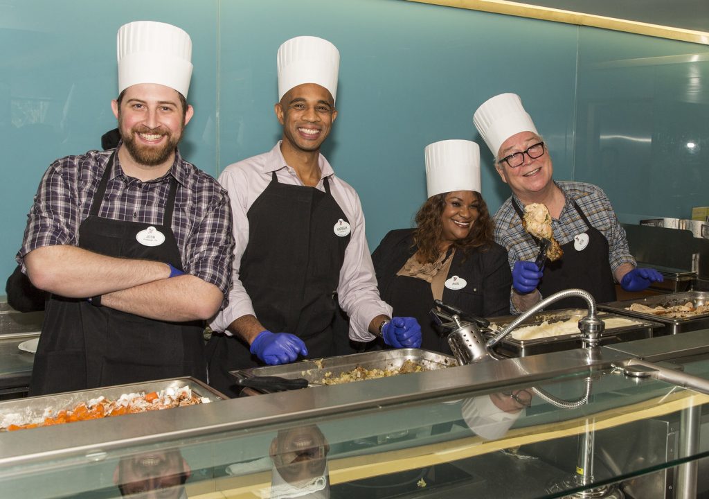 Imagineers serving food at the cafeteria.