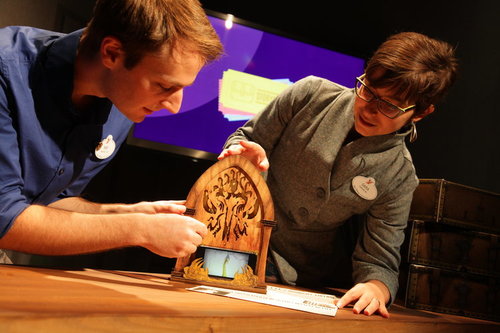 Imagineers looking at a prop.