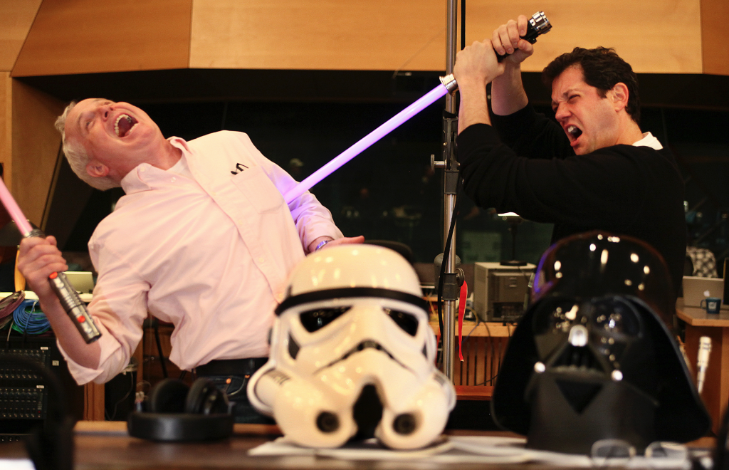 Imagineers using the force with their lightsabers.