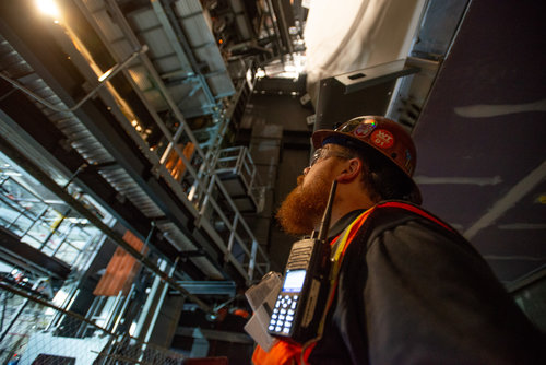 An imagineer on a construction site, taking in the landscape.