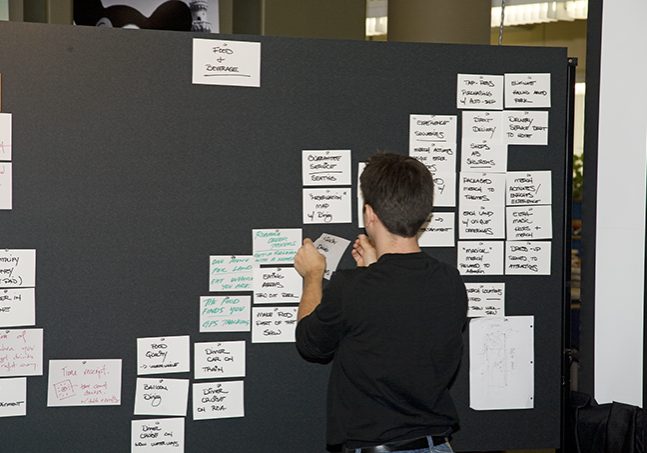 Imagineers working on a concept board.