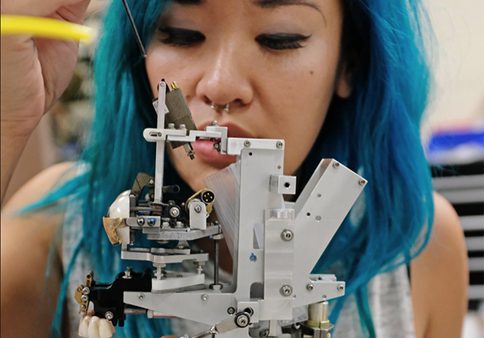 Imagineer working on a mechanical piece.
