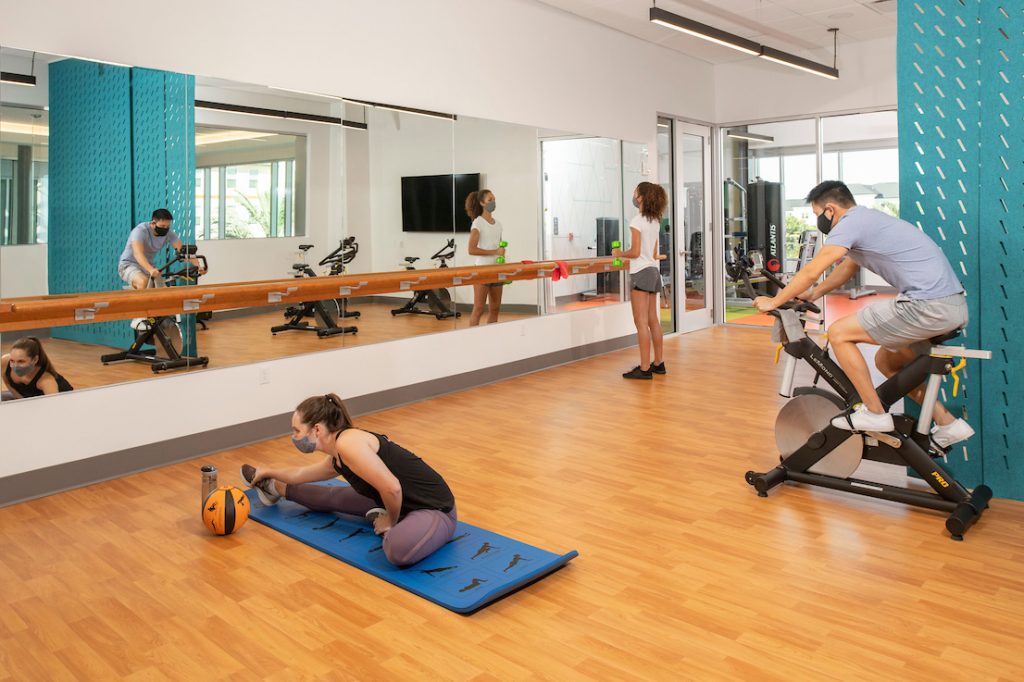 Participants do yoga, ride a bike, and lift weights in one of Flamingo Crossing Village's fitness rooms