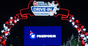 Red and white light up archway with sign that reads: Freeform 25 Days of Christmas Drive-In