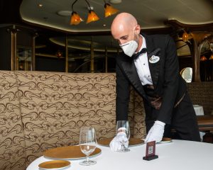 Angelo ensures the dining room is set up beautifully for guests. 