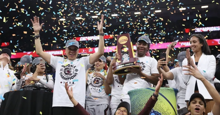 Women of the NCAA Championship celebrating with trophy and confetti