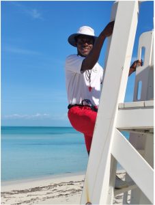 Photo of Castaway Cay island lifeguard, Braven, climbing on his lifeguard chair