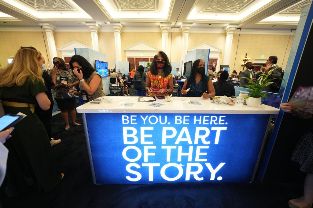 A recruiter ready to connect at The Walt Disney Company career expo booth.
