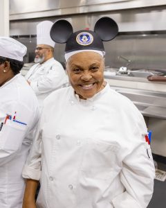 Second Harvest employee wearing Mickey ears in the kitchen