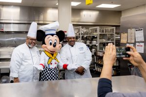 Mickey Mouse and two chefs in the Second Harvest Kitchen