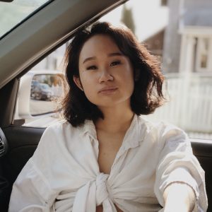 Jennifer Ng sitting in the passenger seat of a car