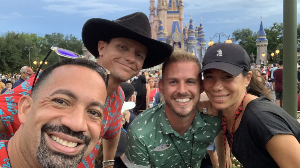 Monse posing with three of her fellow team members at Magic Kingdom Park.