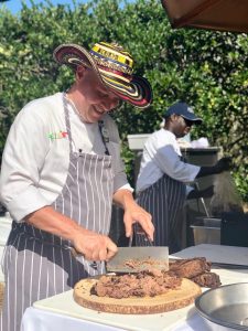 Chef Daniel Contreras chopping meat on a cutting board