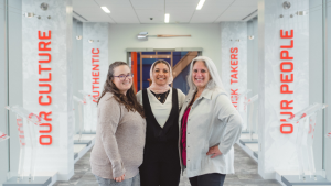 Three women standing in the hallway of the ESPN office in Bristol, CT.