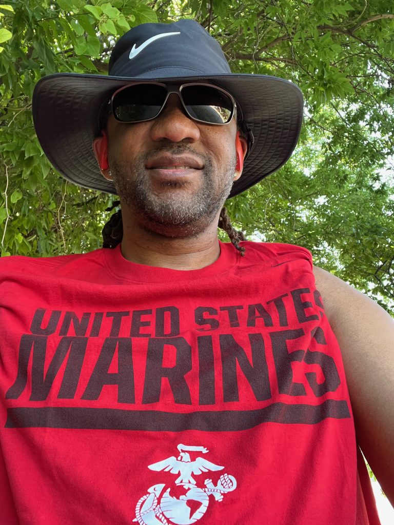 Selfie of Jonathan Williams wearing a red shirt that says United States Marines.