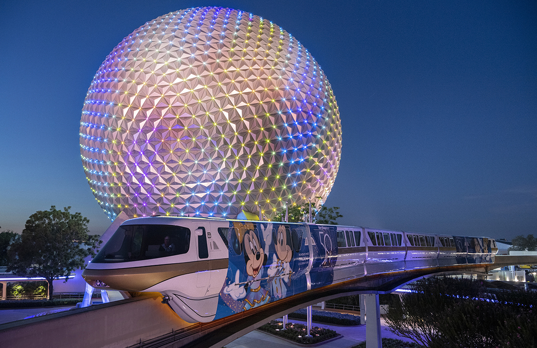 The monorail at dusk in front of the Spaceship Earth attraction at Epcot at the Walt Disney World Resort
