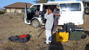 Nat Geo field ready program participants next to a van with all their equipment