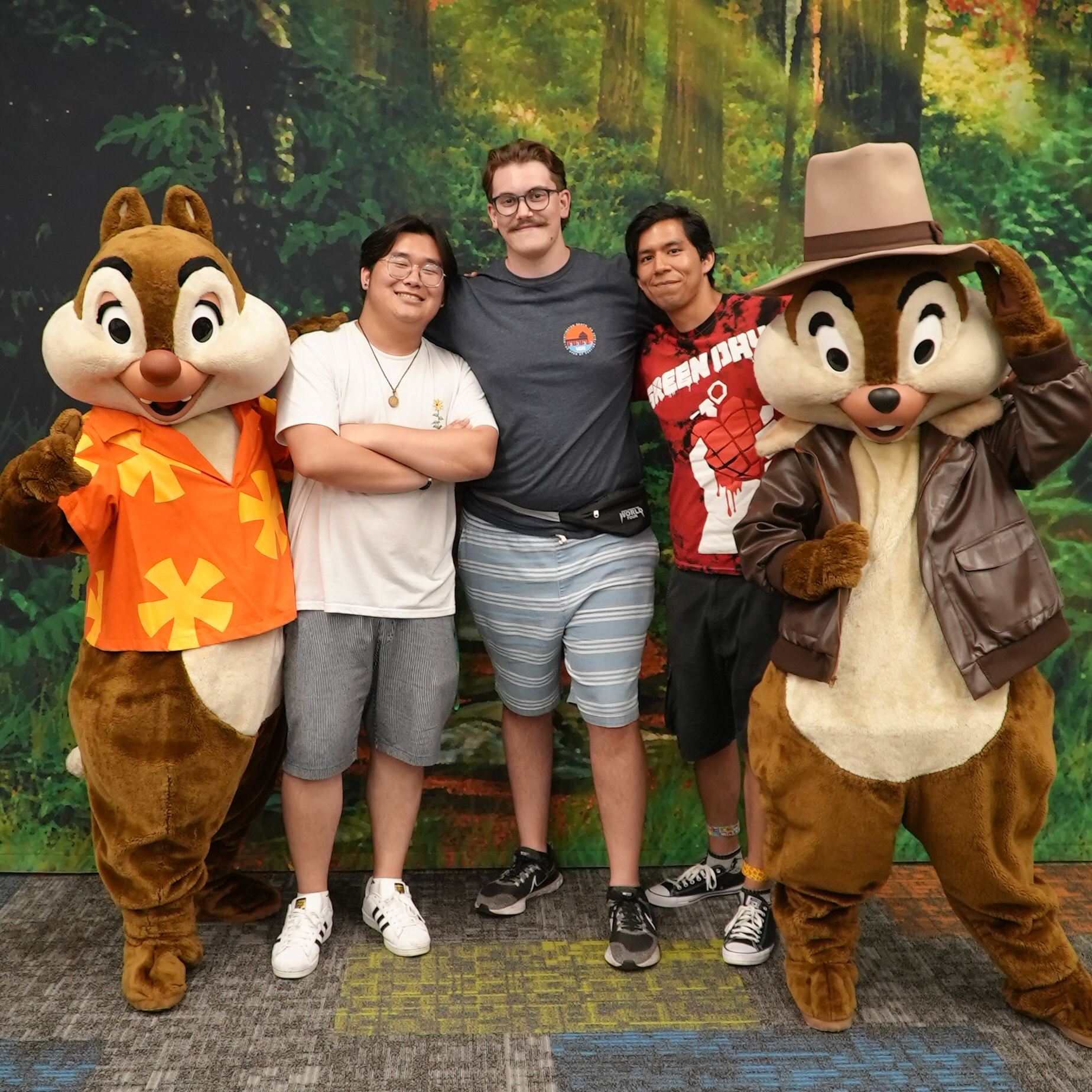 Three male Disney College Program participants pose for a photo standing between Chip and Dale character performers at Walt Disney World Resort
