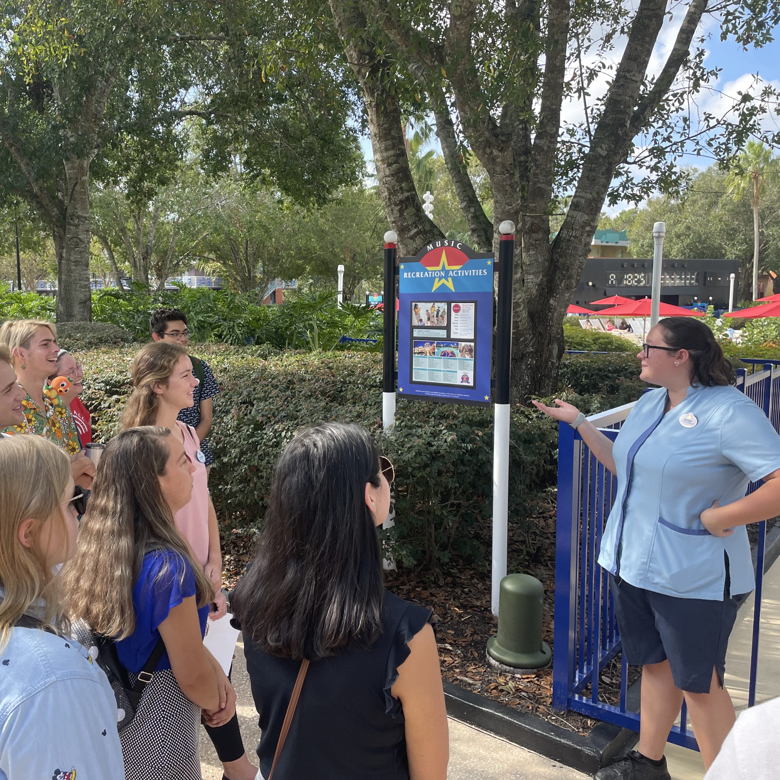 Disney college program participant speaking to a group of visitors at an outdoor location at the Walt Disney World Resort