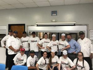 Group of 15 Disney culinary team members smiling 