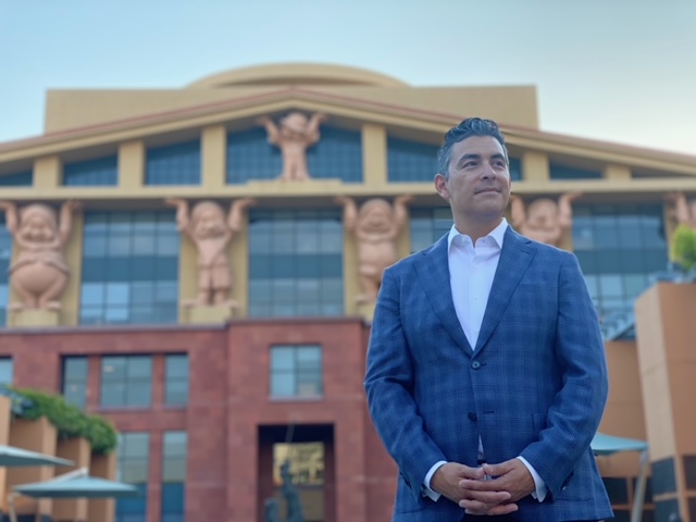 Daniel Vasquez poses in front of Team Disney – The Michael D. Eisner Building.