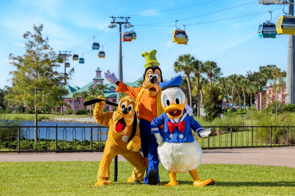 Pluto, Goofy and Donald Duck posing for a photo