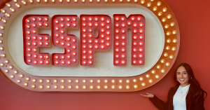 Celene stands in front of an ESPN sign
