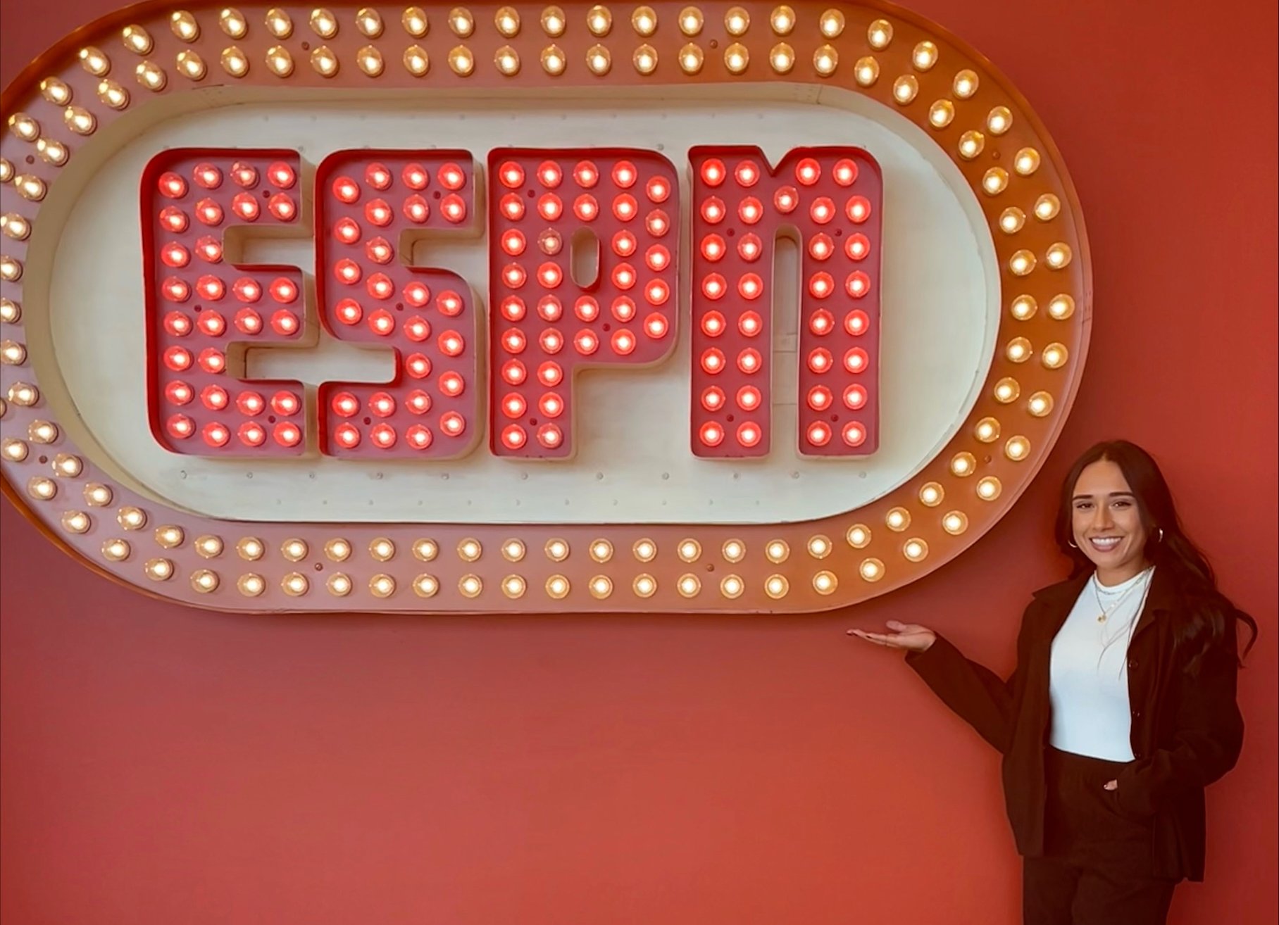 Celene stands in front of an ESPN sign