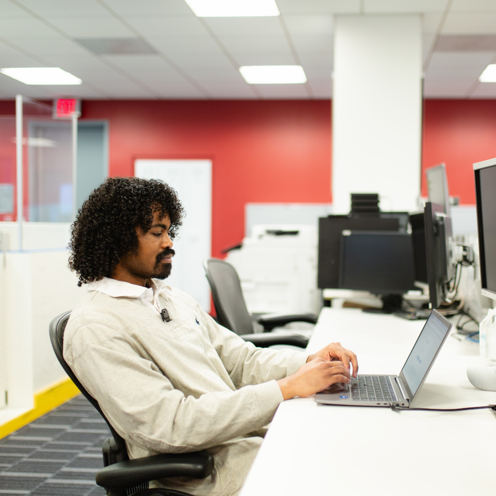 Lenny works on his laptop at a desk