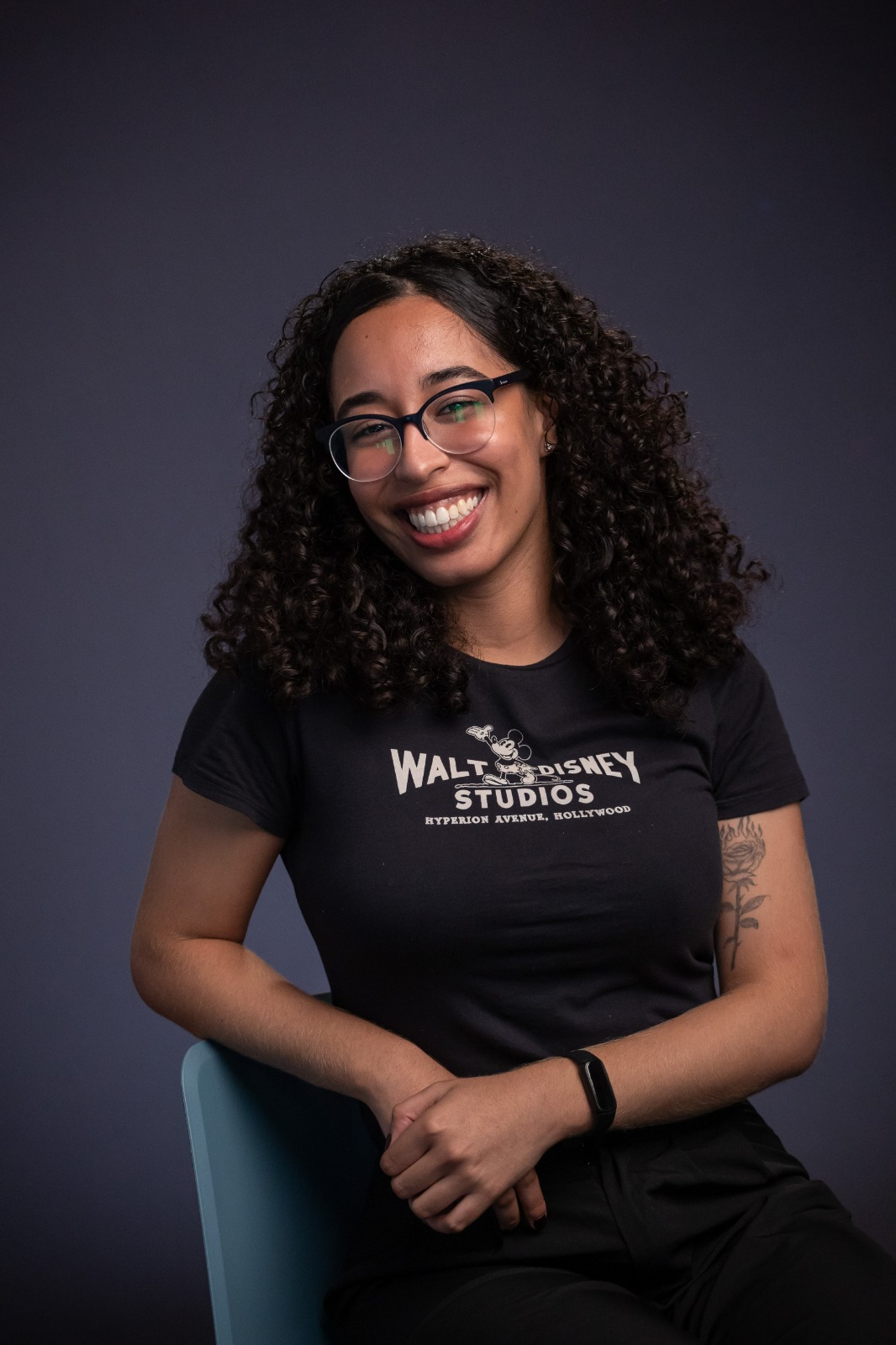 Smiling professional in a The Walt Disney Studios shirt posing for a headshot