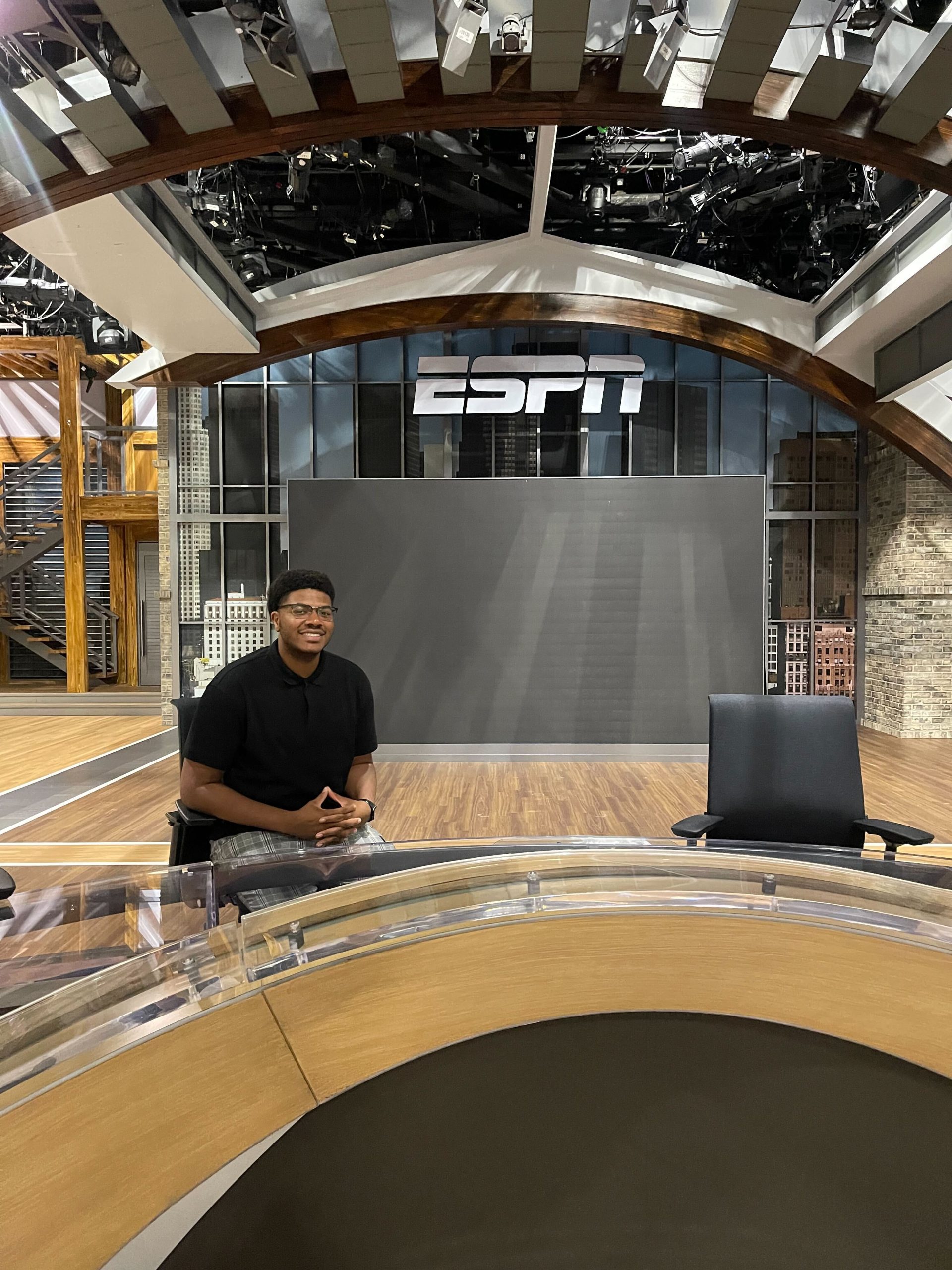 Payton sits at an ESPN anchor desk