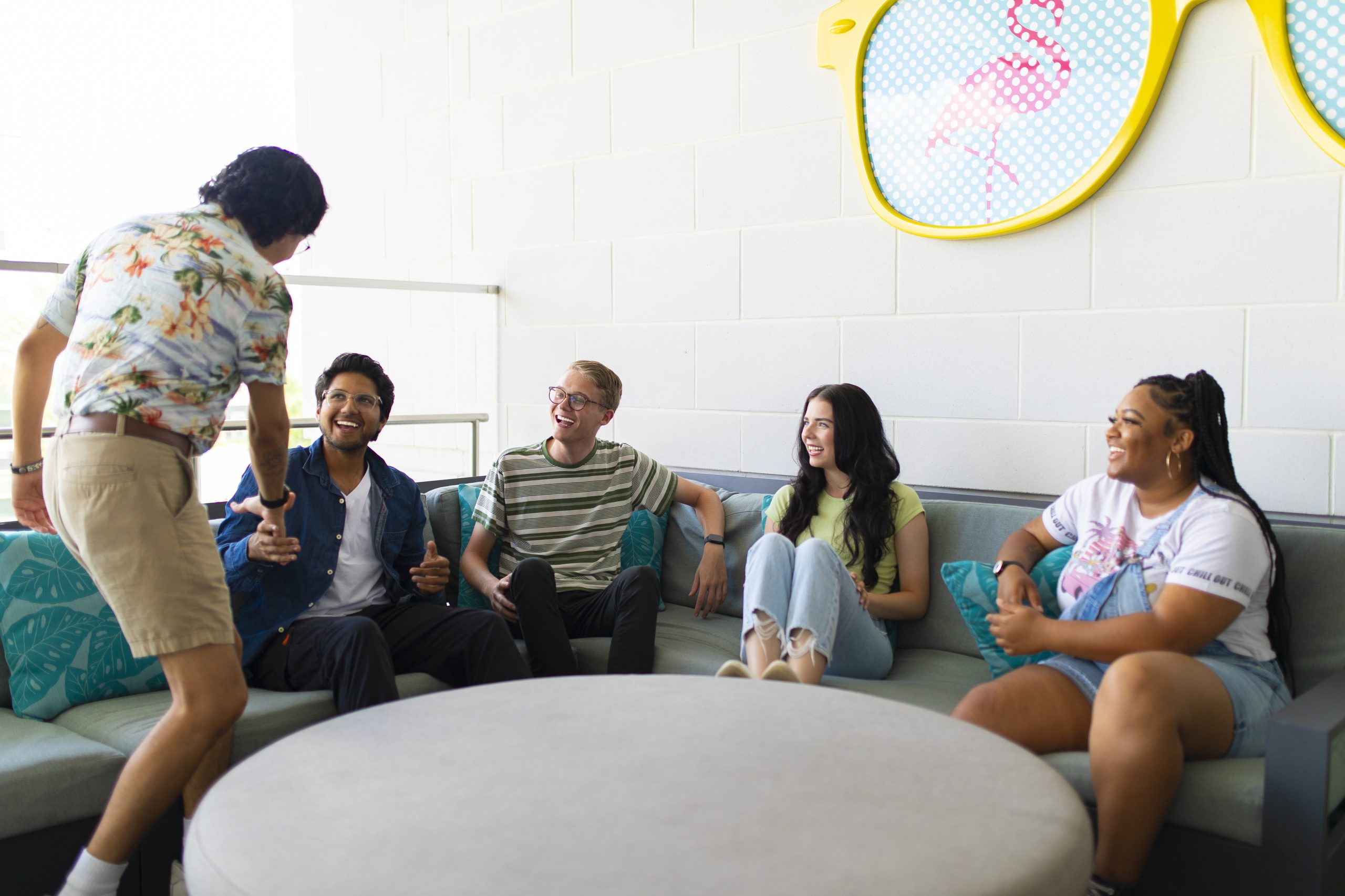 a group of people chatting on a couch outdoors