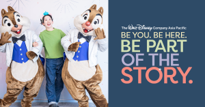 A woman posing with Chip and Dale next to a graphic that reads "Be You Be Here Be Part Of the Story"