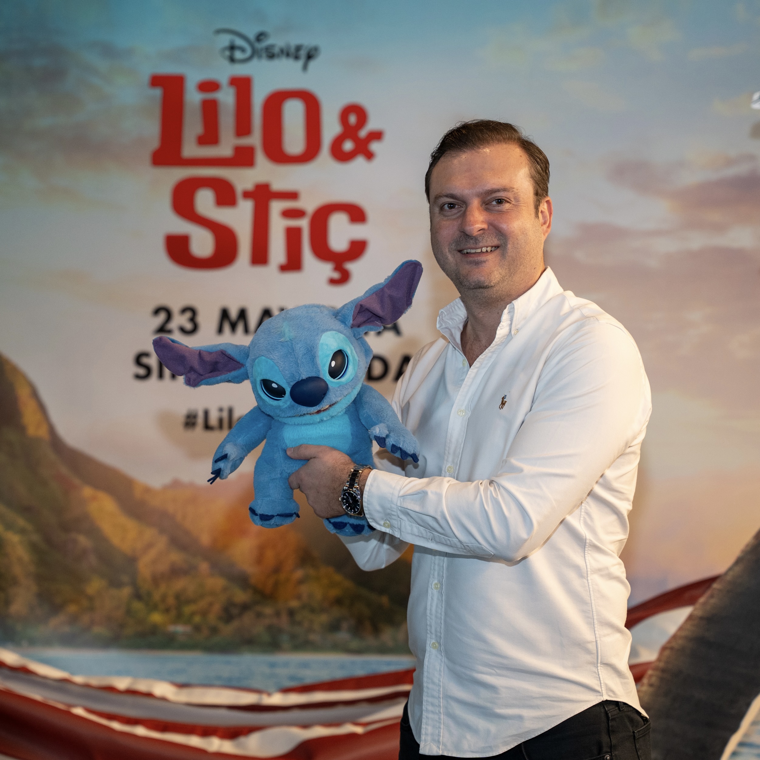Onur 01 man posing with a plushie of Stitch from Lilo & Stitch