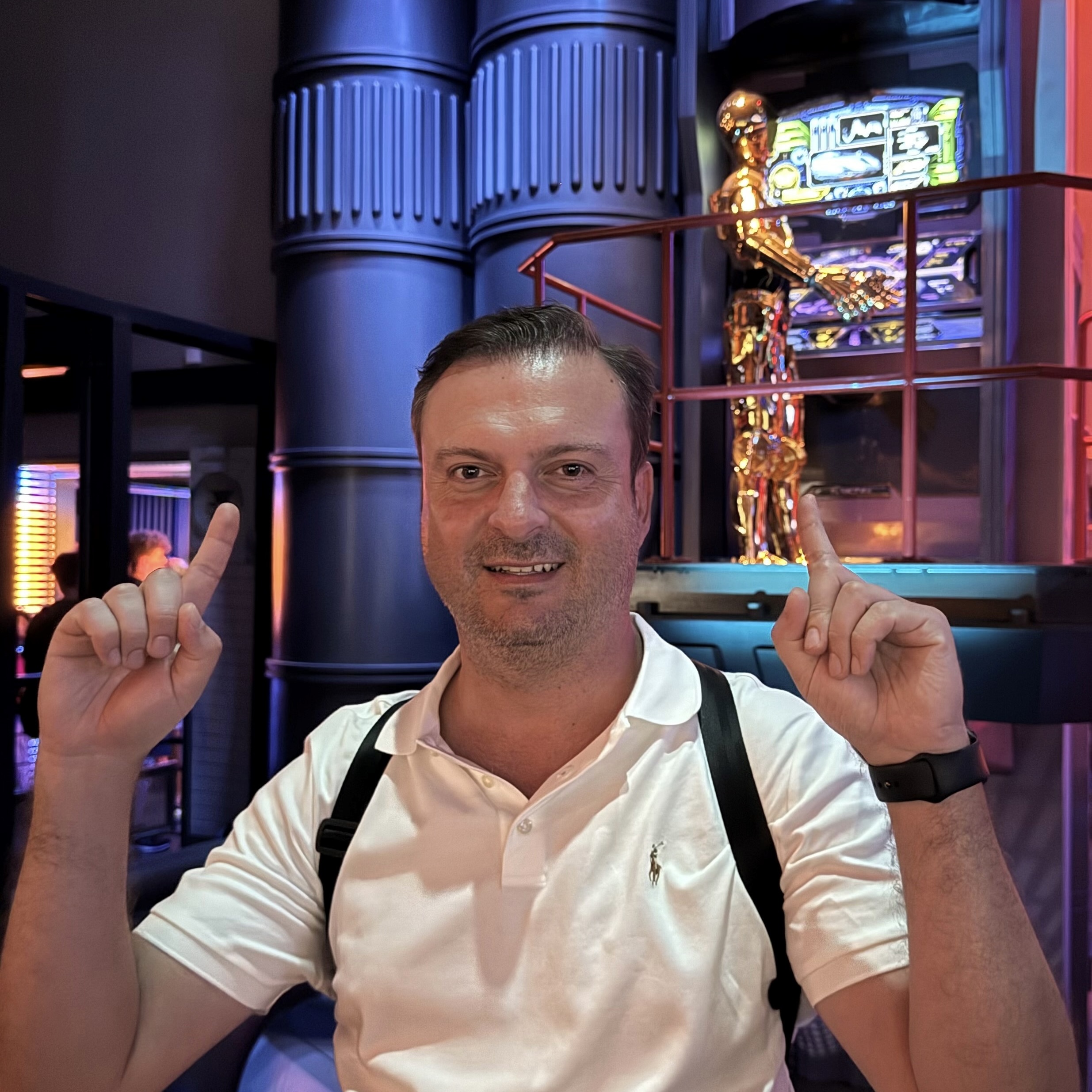 Onur Disneyland 2 man posing with C-3PO from Star Tours at the Disneyland Resort