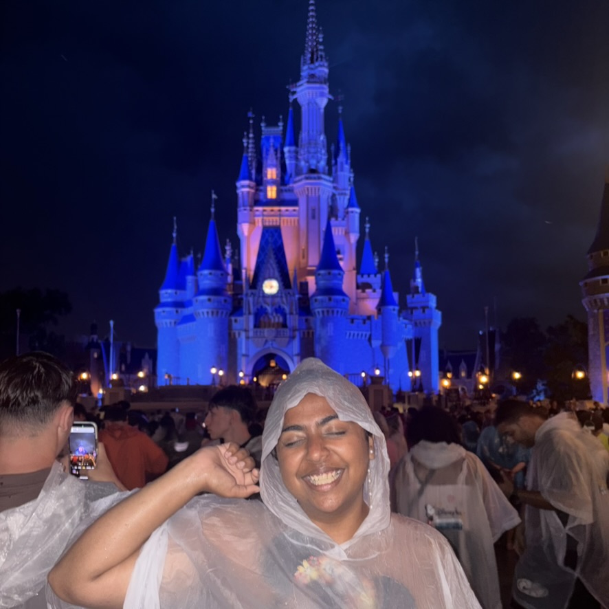 woman smiling in front of Cinderella Castle at Magic Kingdom Park