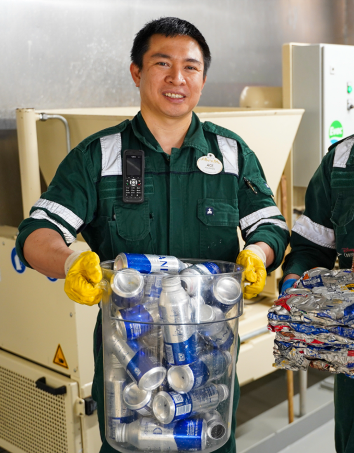 Ace holds a bin of recyclables.