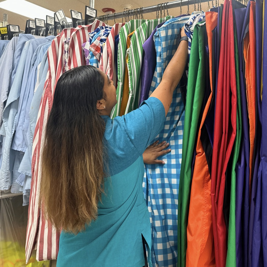 woman flipping through costume garment bags