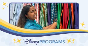 woman flipping through costume garments while smiling