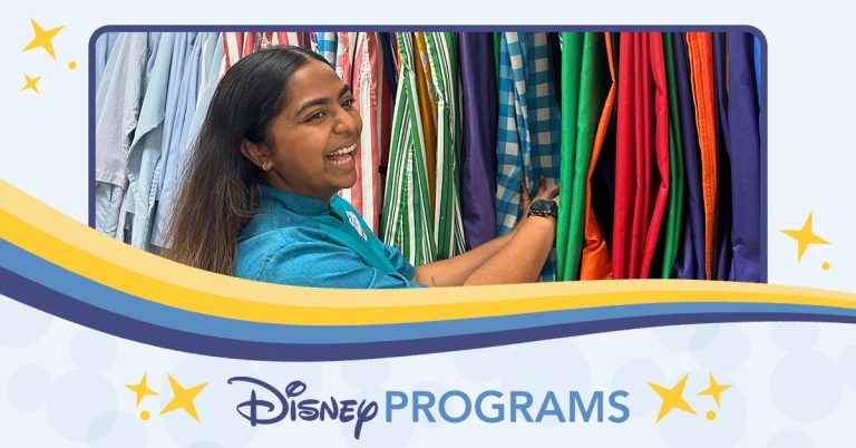 woman flipping through costume garments while smiling