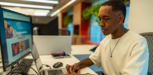 Photo of intern in front of computer