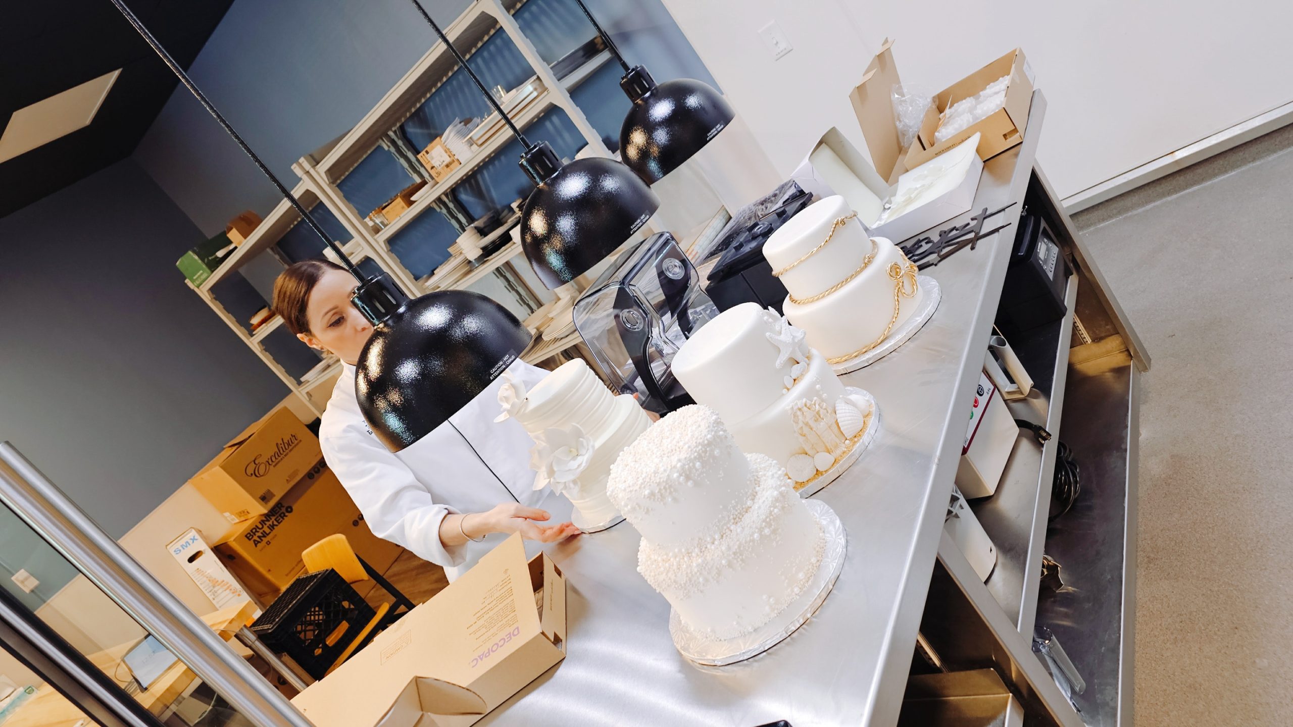 Chef Grace with the newly designed wedding cakes. Chef Grace with the newly designed wedding cakes.