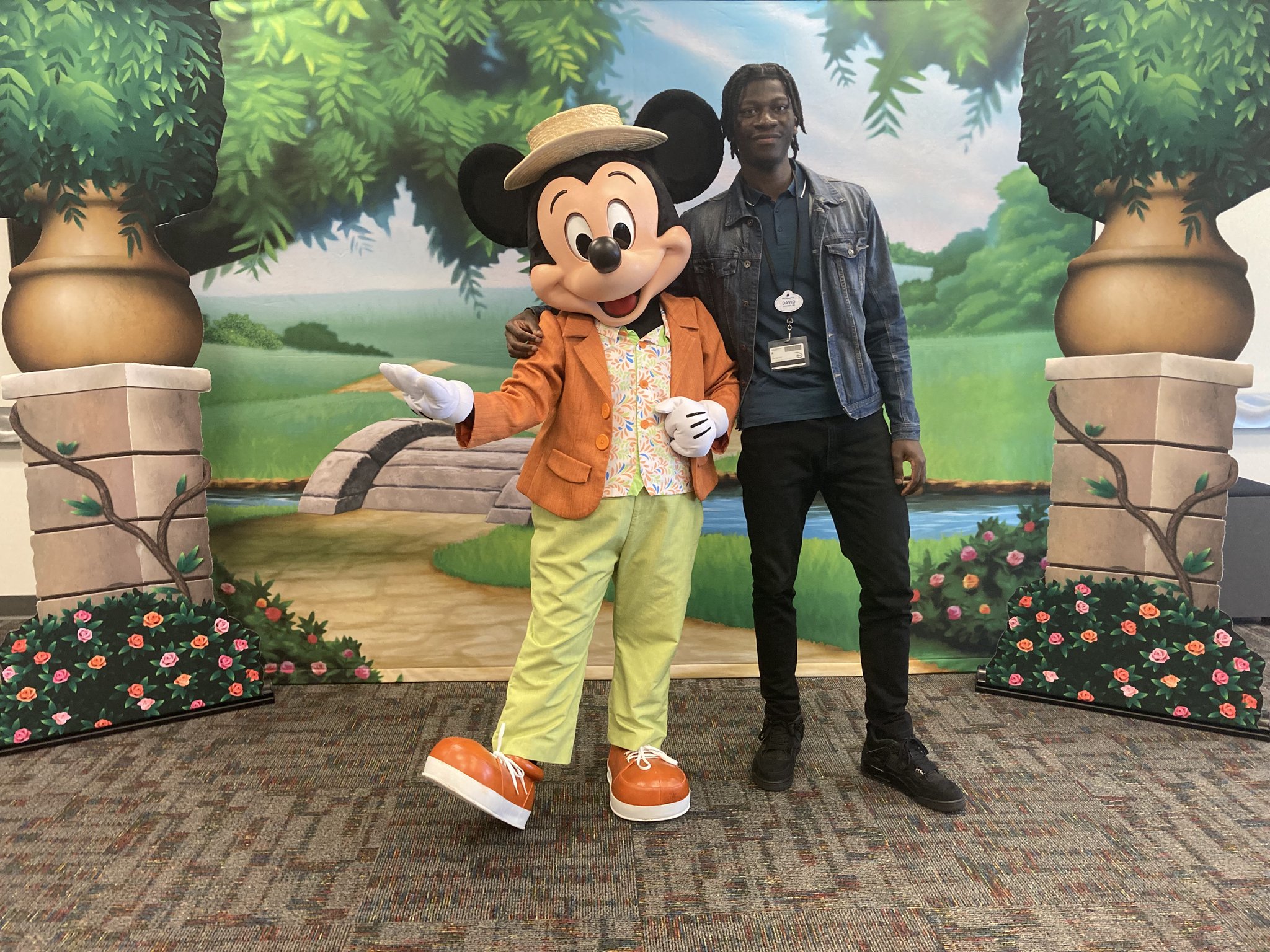 Intern posing with Mickey Mouse