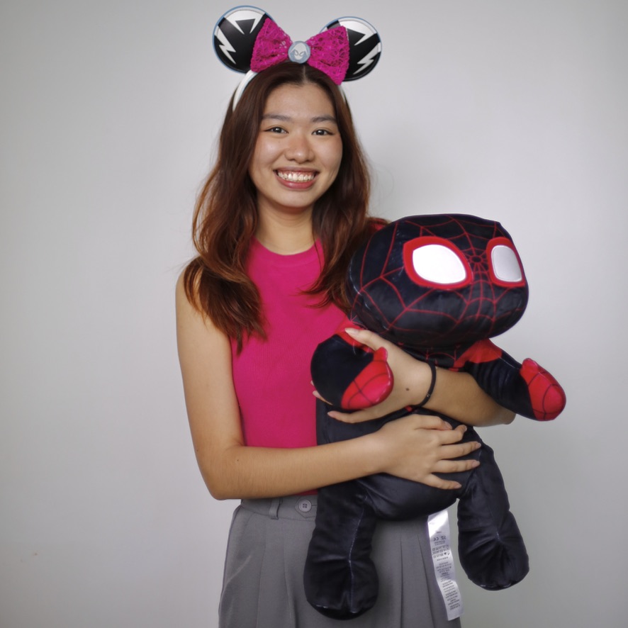 3A16C185-54CE-4F01-B641-D4F64685E924_1_105_c A person wearing Mickey Mouse ears holds a Spider-Man plush toy in front of a plain white background.