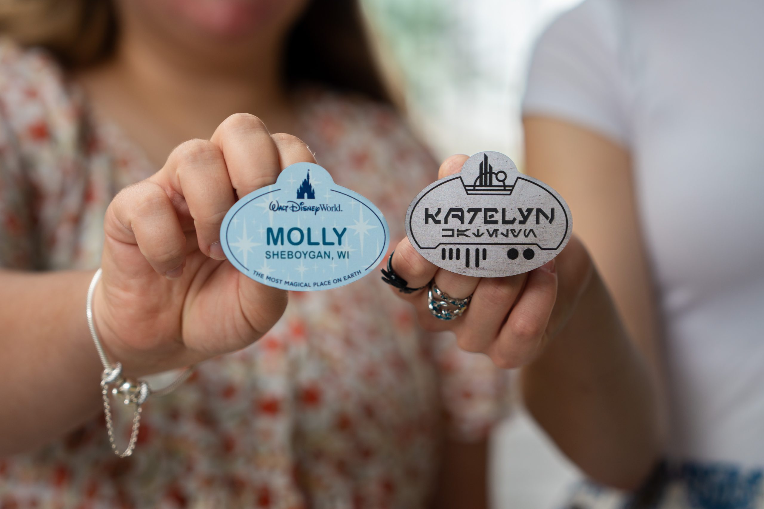 A close-up shows two hands holding name tags labeled "Molly" and "Katelyn."