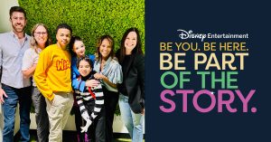 Cast of "Vampirina: Teenage Vampire" posing with employees from Disney Branded Television. Text on the right reads: "Disney Entertainment. Be You. Be Here. Be Part of the Story."