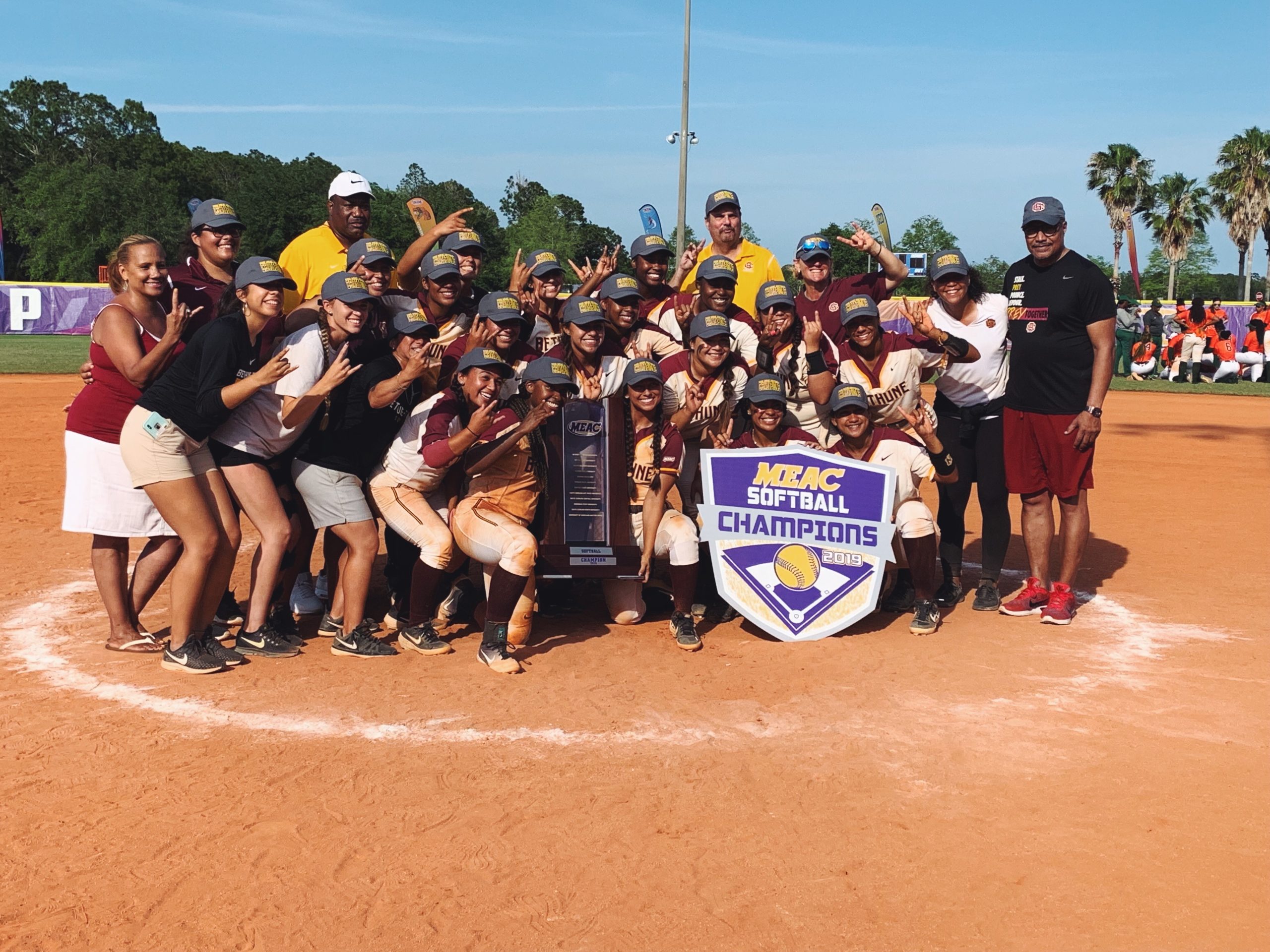 Destiny posing with her softball teammates after winning the MEAC Championship