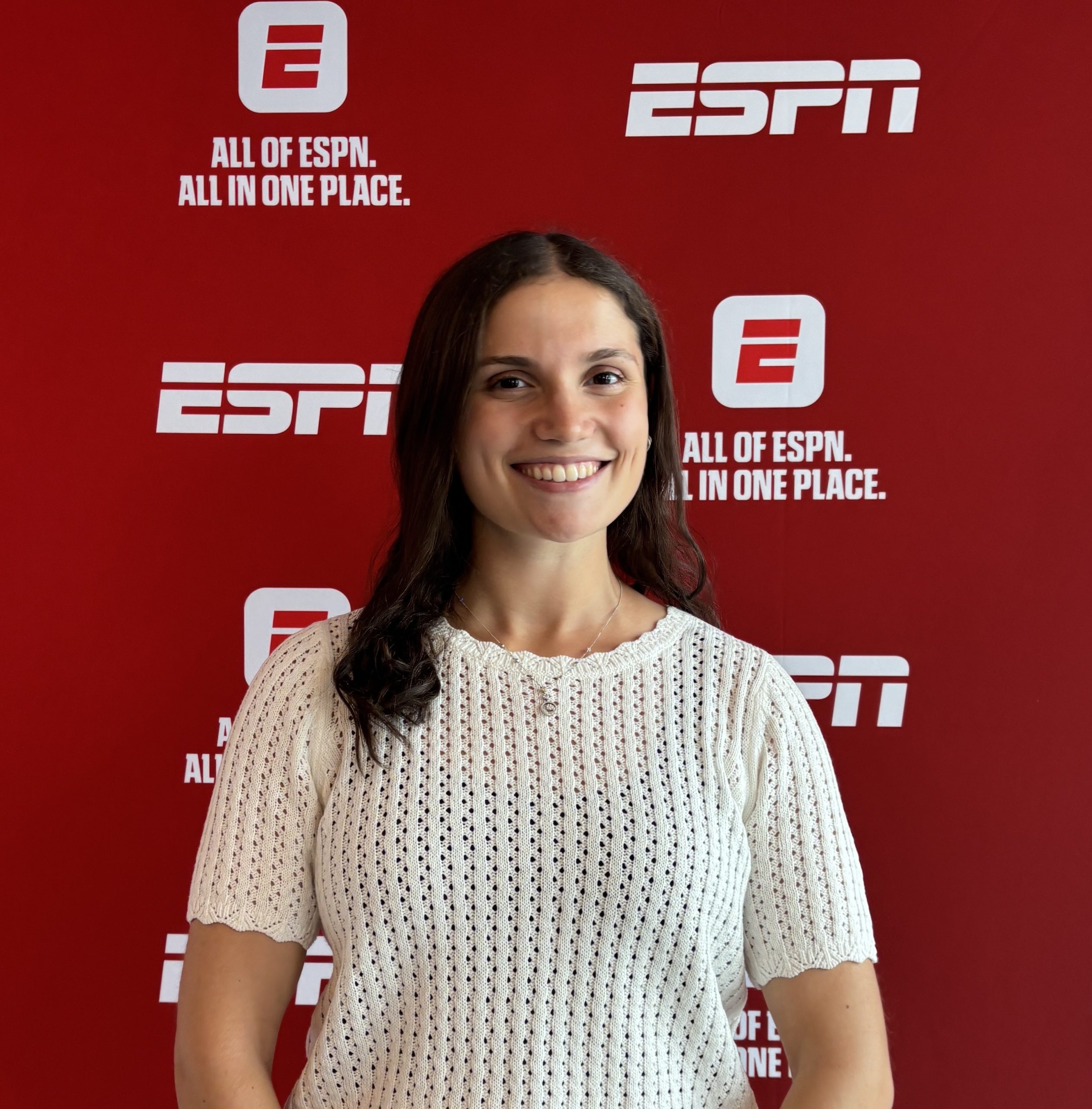 Person standing in front of a red ESPN backdrop