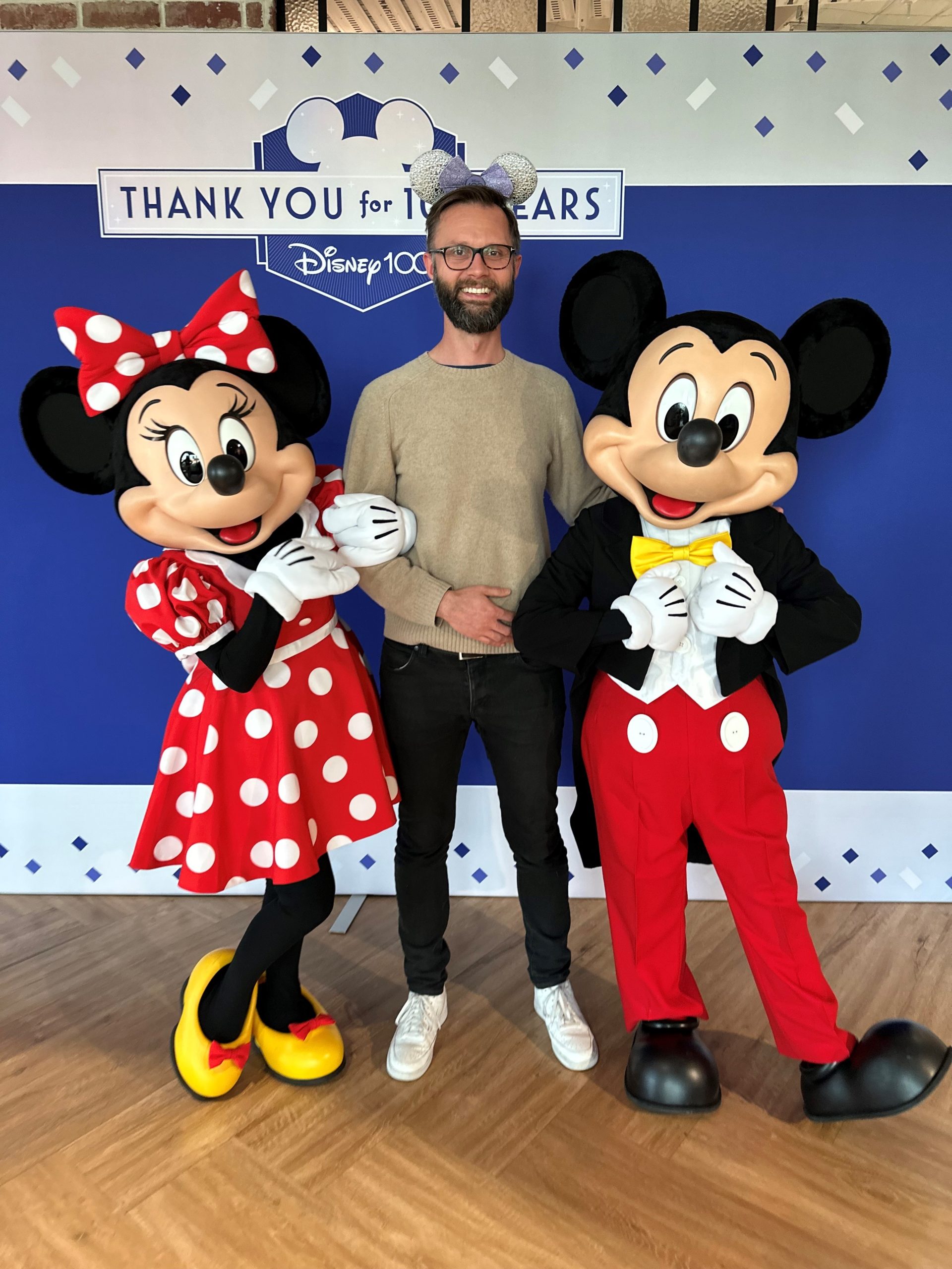 Peter with Mickey and Minnie Mouse at Disney 100 celebration.