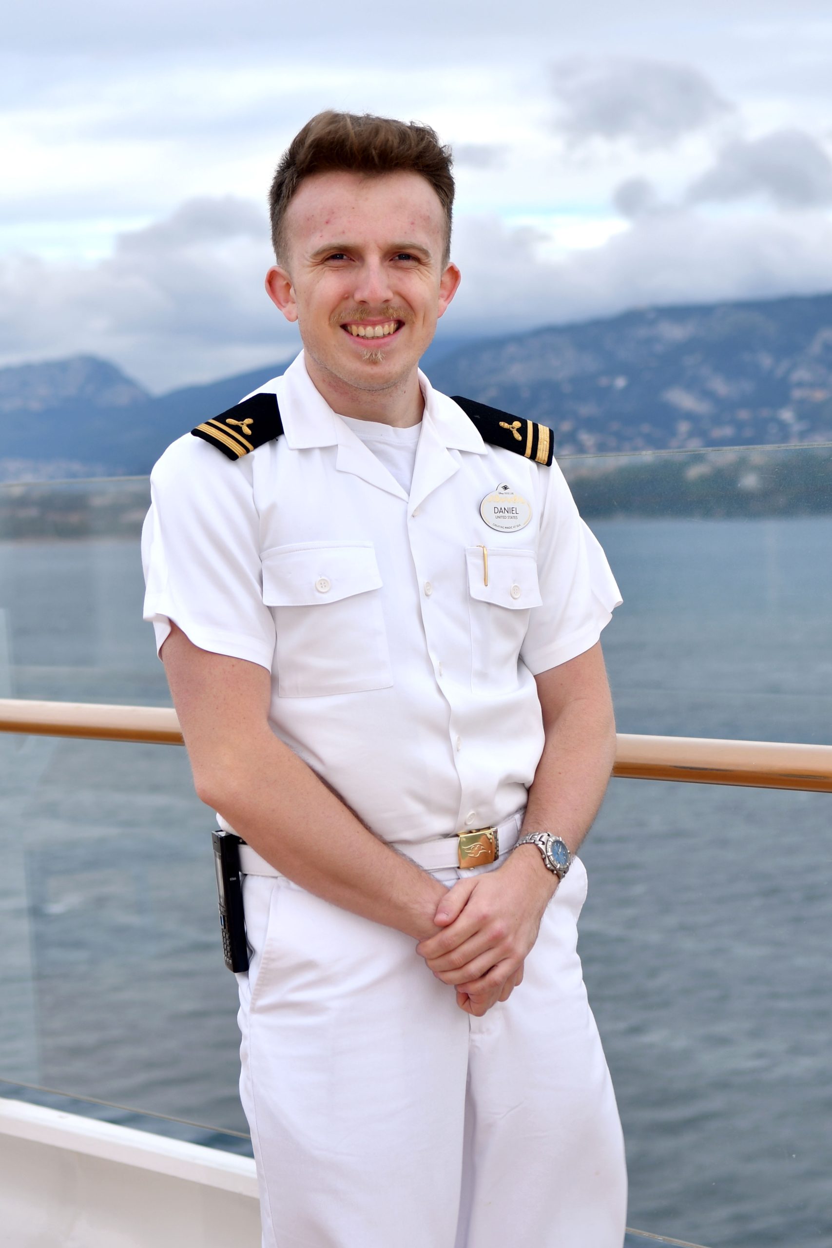 Third Engineer Daniel photographed against a scenic ocean view.